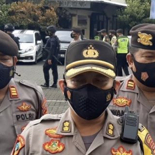 Tiga polisi sedang berjaga-jaga di salah satu gereja di Semarang untuk mengamankan perayaan Paskah.