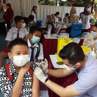 Ilustrasi pelaksanaan PTM menggunakan prokes sangat ketat, salah satunya dengan penyuntikan vaksin untuk menghindari penyebaran virus Corona