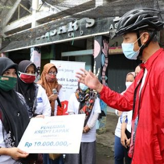 Gubernur Jawa Tengah, Ganjar Pranowo, menyerahkan secara simbolis dana pinjaman dari program kredit Lapak kepada ibu-ibu pedagang Pasar Salaman Magelang, Sabtu (27/11)