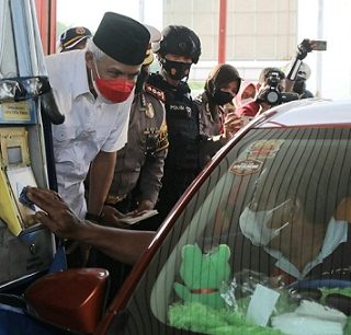 Gubernur Jateng Ganjar Pranowo menyapa sejumlah pengendara yang melintas Gerbang Tol Kalikangkung, Jumat (24/12) sore