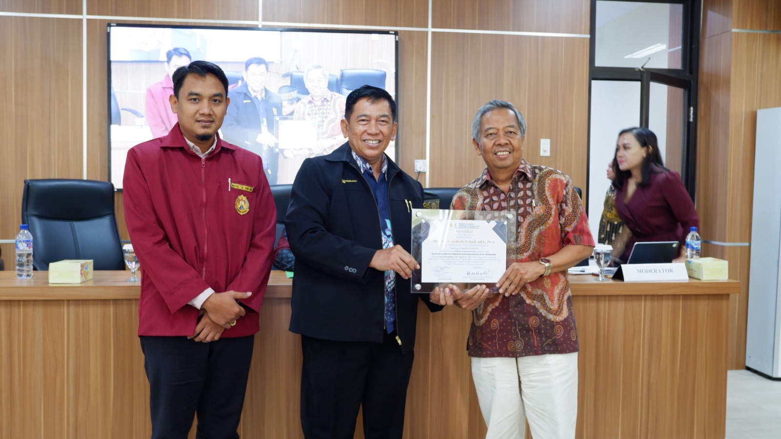 Kaprodi S2 Hukum USM Dr Drs H Adv Kukuh Sudarmanto BA SSos SH MM MH menyerahkan piagam kepada narasumber Prof H Sudharto P Hadi, MES, PhD didampingi Ketua Panitia Seminar Hukum Nasional, Haizul Maarif SH